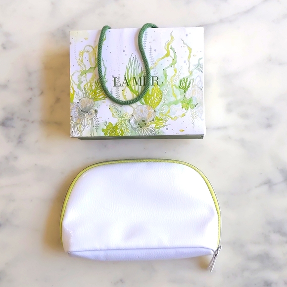 La Mer Handbags - NWT. LA MER Cosmetic Bag with Multicolor Design Paper Bag.